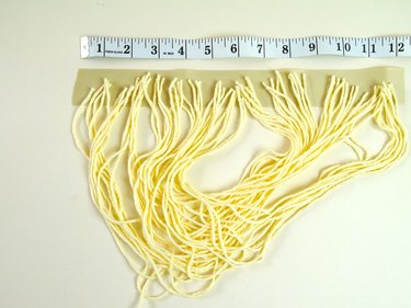 Glued yarn tips to a ribbon.