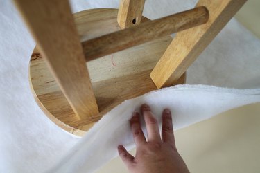 Staple the batting to the stool.