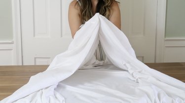 Bringing two corners of the sheet together