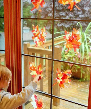 One leaf centered in each pane of large window