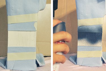 spray painting a decorative stripe to the buoy