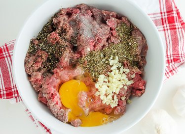 Bowl containing meatball ingredients.