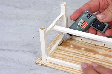 driving screws through the apron to attach the table top