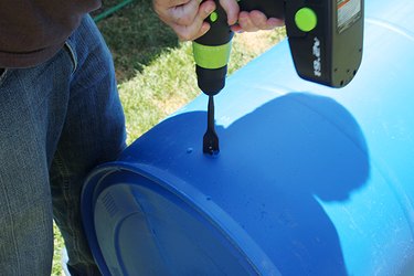 drilling a hole into the plastic barrel