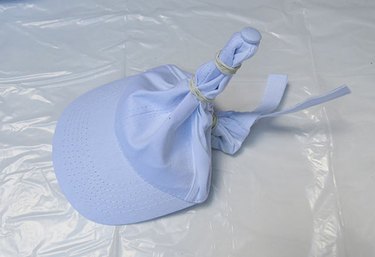 Wrap rubber bands around hat.