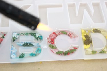 use a flame to remove air bubbles