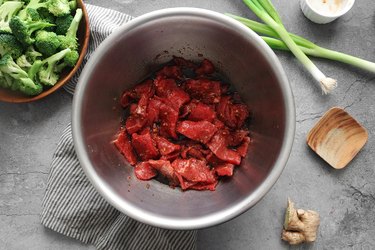 Strips of beef in a large bowl