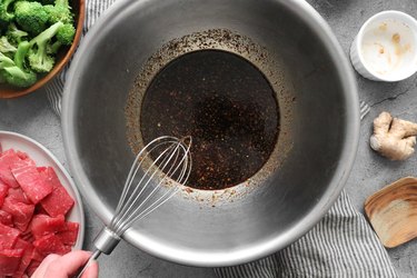 Marinade ingredients being whisked in a large bowl
