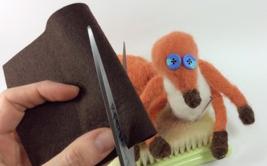 Female hands holding brown a wool felt sheet