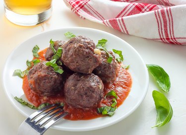 Meatballs covered in roasted garlic tomato sauce.