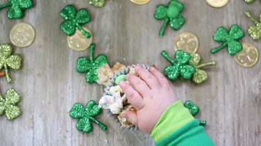 little leprechaun hand reaching for some munch mix