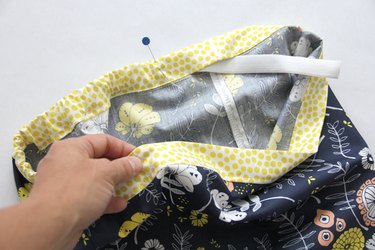 Pin the other end of the elastic in place so that it doesn't slip into the casing