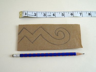 Folded paper with a zigzag design drawn on half.