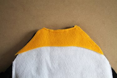 Topstitch the yellow neckline detail to the neckline of the front body.