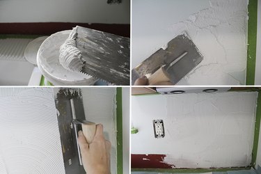 Applying mastic to wall.