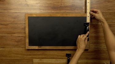 Marking placement of front-mounting cabinet pulls for DIY chalkboard serving tray.