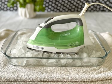 Place unplugged hot iron into pan of ice cubes