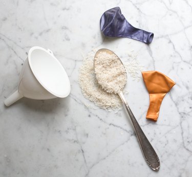 Materials needed to make a homemade stress ball: balloons, spoon, funnel and rice