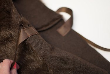 Sew the ribbon to the front of the cape.