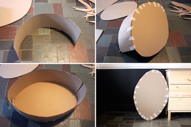 taping strips to cardboard football shape