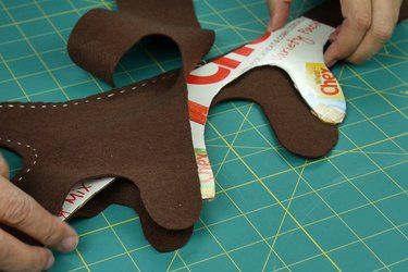 Slide cardboard between layers of felt and stitch in place.