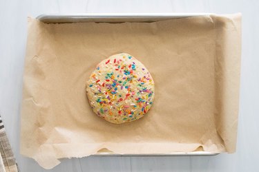 Single-serving birthday cake cookie on baking sheet