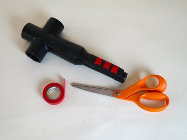The handle unit with red electrical tape decorative buttons.