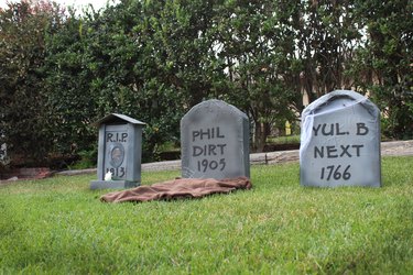 Row of DIY tombstones in front yard
