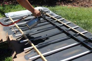 Spray painting the fence.