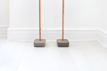 concrete feet with copper rails