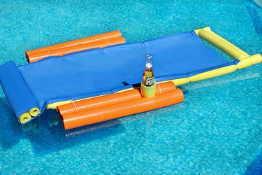 floating lounge chair on the water with a beer in cup holder
