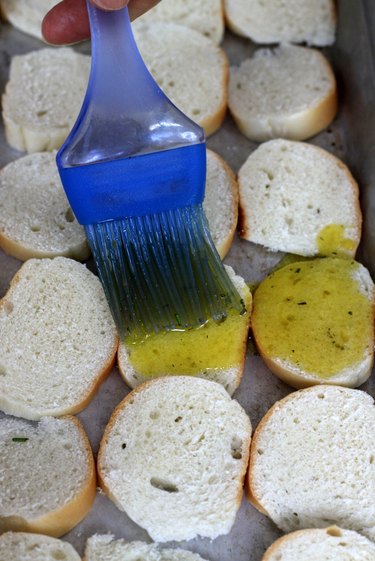 brush oil mixture on bagel chips