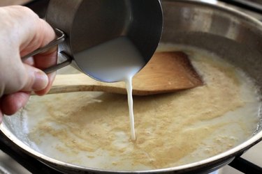 Milk going into the sauce.