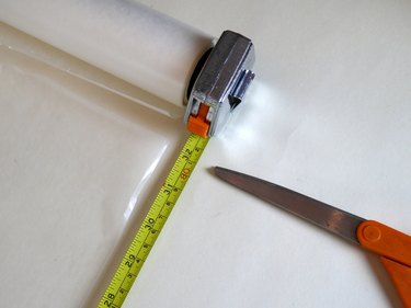 A measuring tape showing wax paper cut at 32 inches.