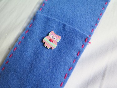 The owl button sewn onto the DIY felt pencil case