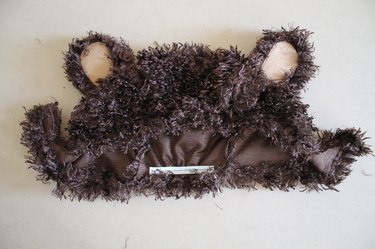 Pull the elastic while you sew it onto the hood.