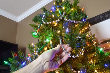 Drape beads around the tree