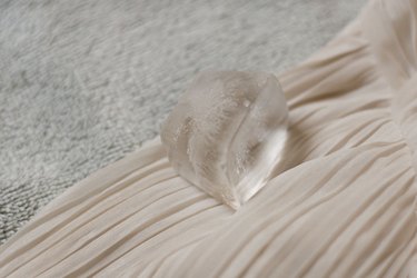 ...Cube of ice placed on chiffon fabric