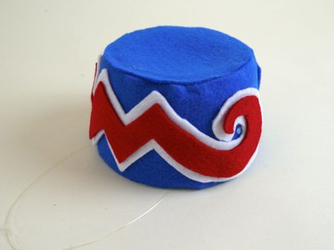 The finished cap with the felt zigzag designs.