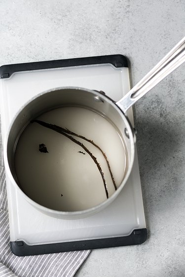 Pot filled with water, sugar, and vanilla to make vanilla-flavored simple syrup