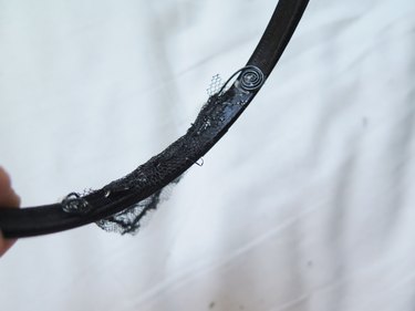 Hot gluing the extra fabric onto the headband.