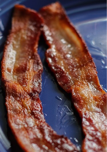Cooked bacon on a plate.