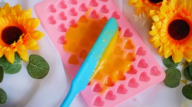 spreading fruit mixture into pink heart mold