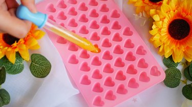 filling pink heart mold with pipette
