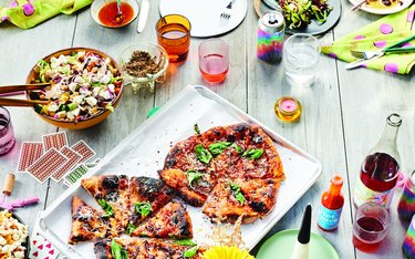 Pizza and other dishes on a wooden table
