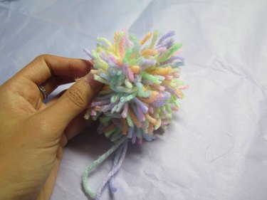 A yarn pompom before trimming