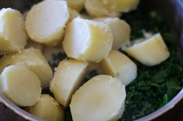 Cooked Russet potatoes cut in pot