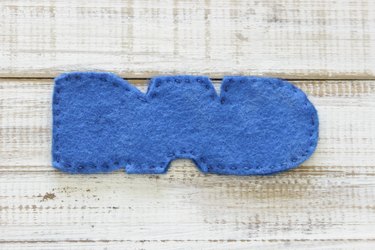 Both pieces of "DAD" design on felt, sewn together along perimeter with embroidery thread.