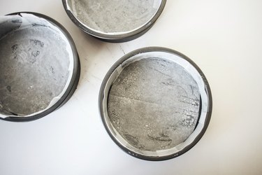 Three greased and lined cake pans.