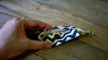 Sewing button onto DIY dog waste bag dispenser